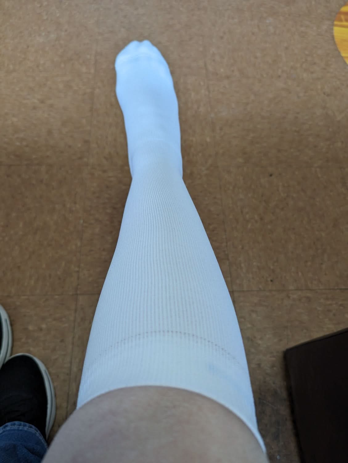 Over-the-calf compression stocking worn on the leg