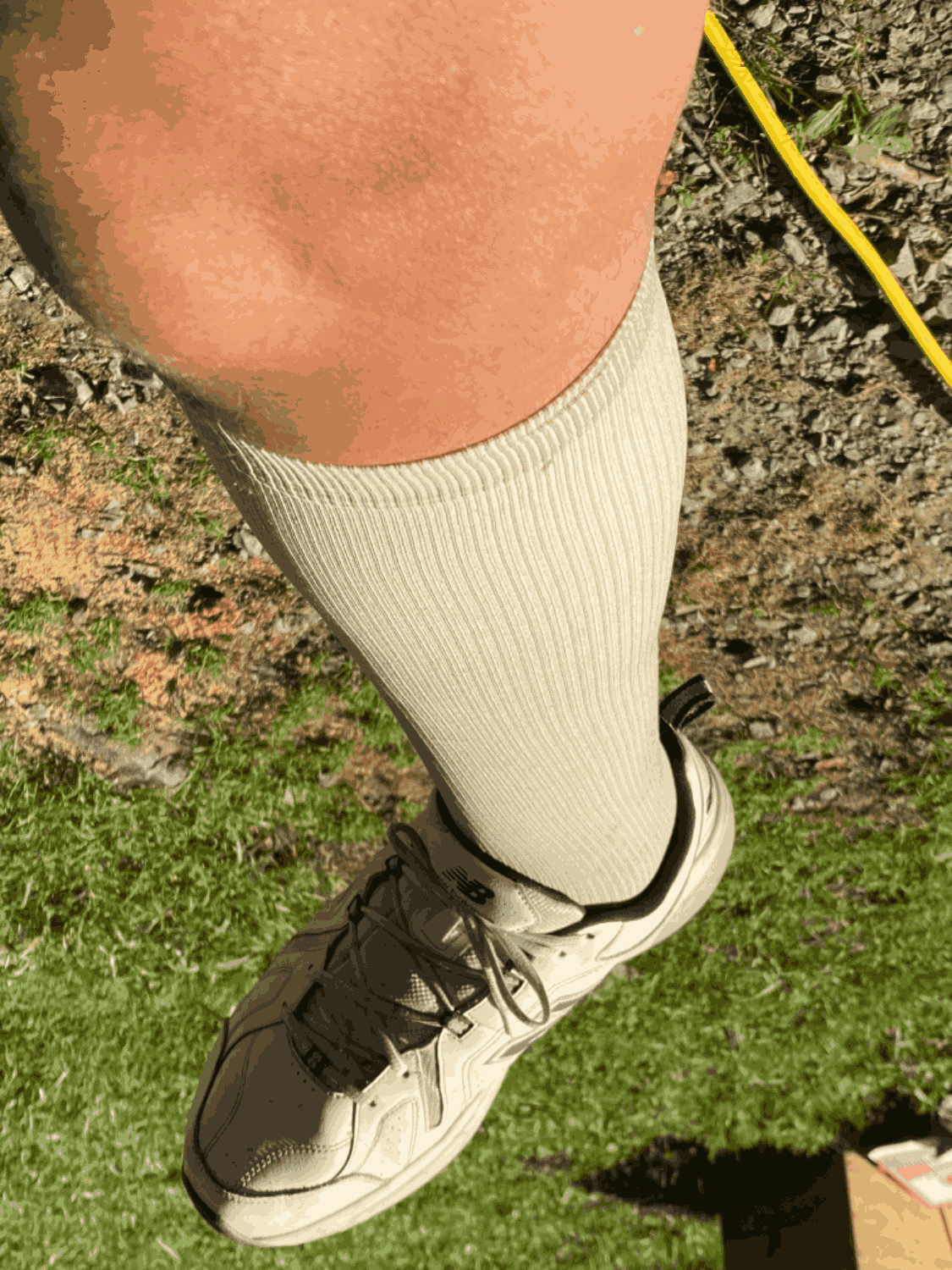 Men's over-the-calf compression socks worn on leg